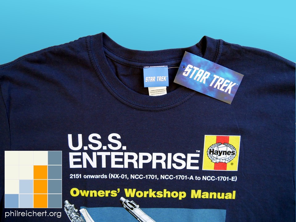 Close-up of the collar and neckline of the Star Trek USS Enterprise Haynes T-shirt with visible licensing tag and stitching