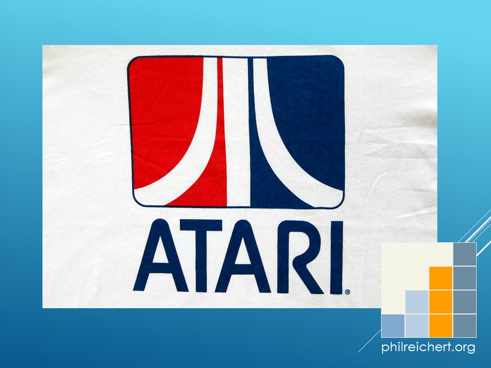 Close-up of the central Atari logo on the T-shirt, showing the red, white, and blue boxed emblem and the ATARI wordmark beneath