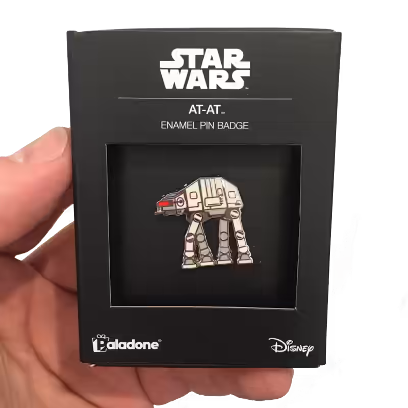 Detailed view of an AT-AT walker enamel pin highlighting its metal finish, clean linework, and compact badge scale