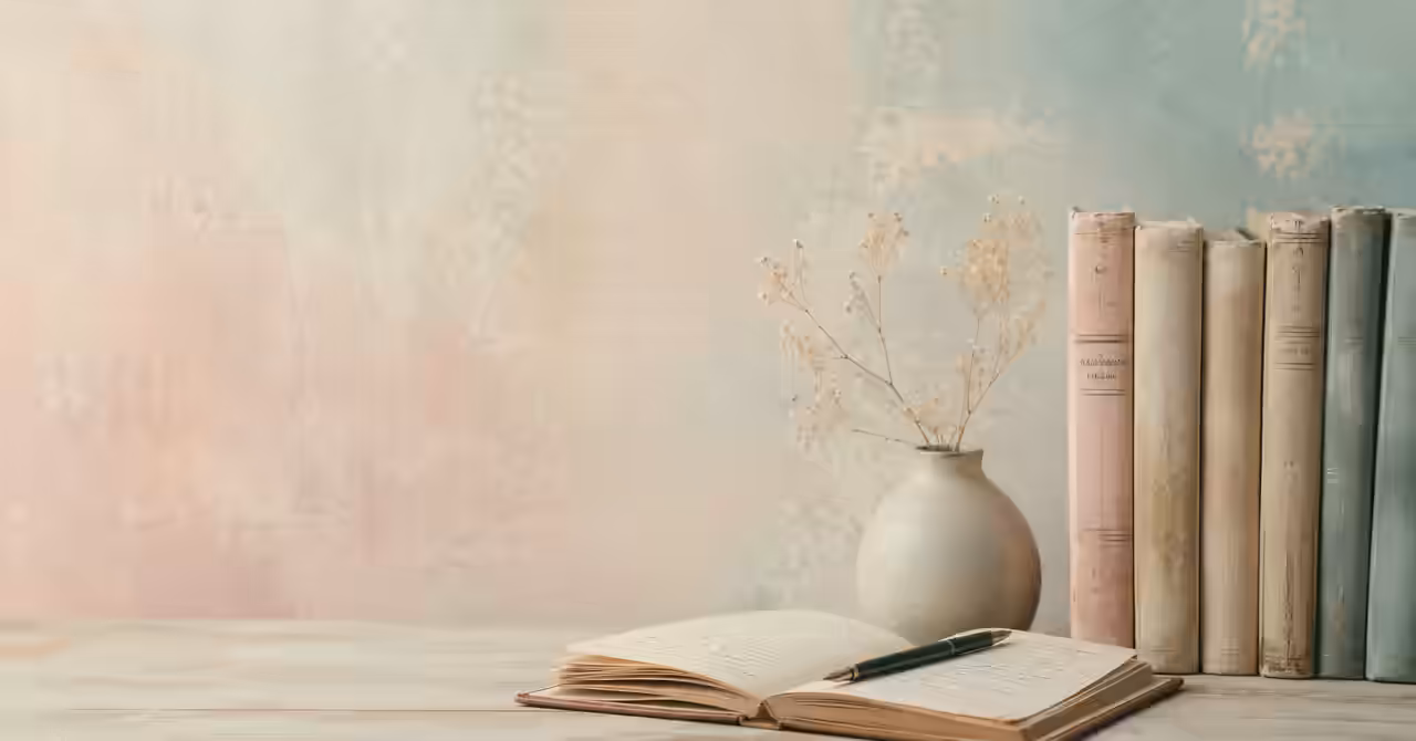 Pastel-toned books, handwritten notes, and a journal arranged on a quiet desk against a softly textured background.