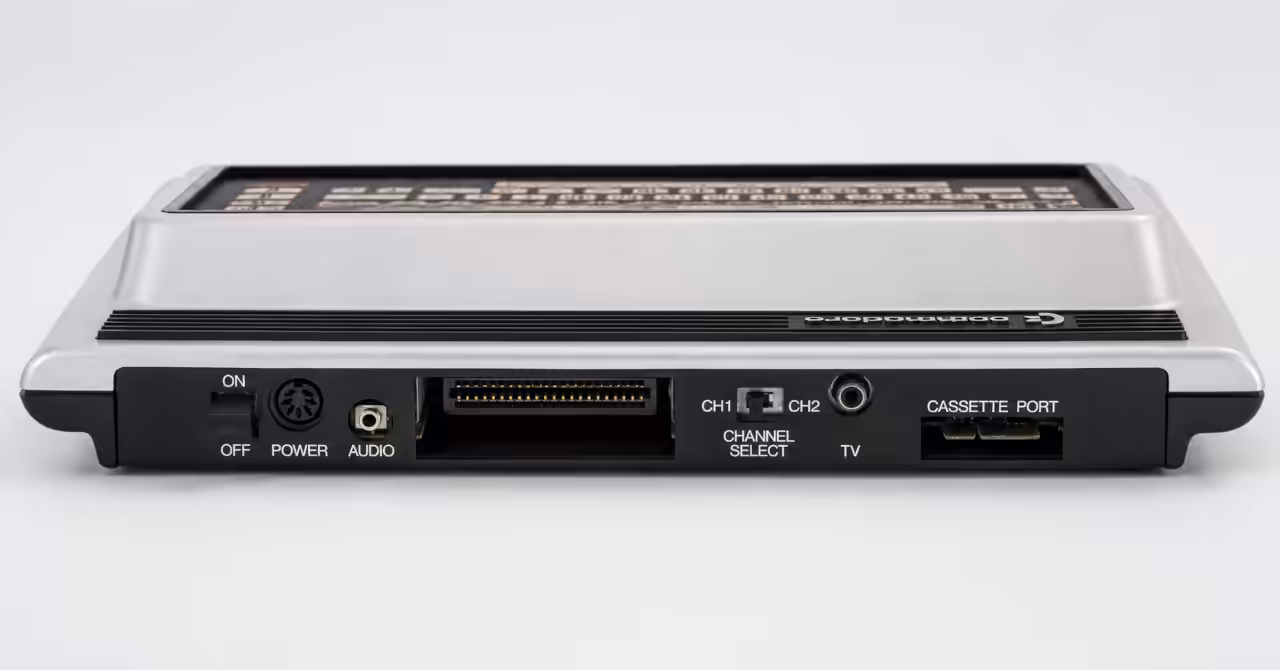 Rear view of a Commodore MAX Machine showing the power switch, power connector, audio output, cartridge expansion port, channel select switch, TV output and cassette port.